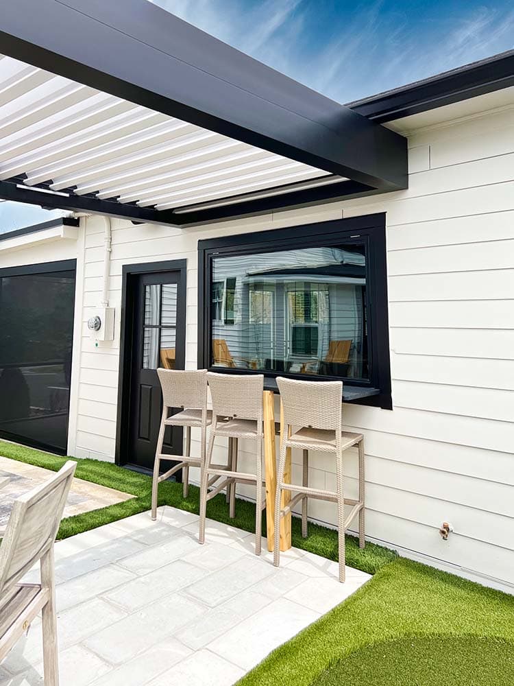 Black frame pergola with white louvered roof panels