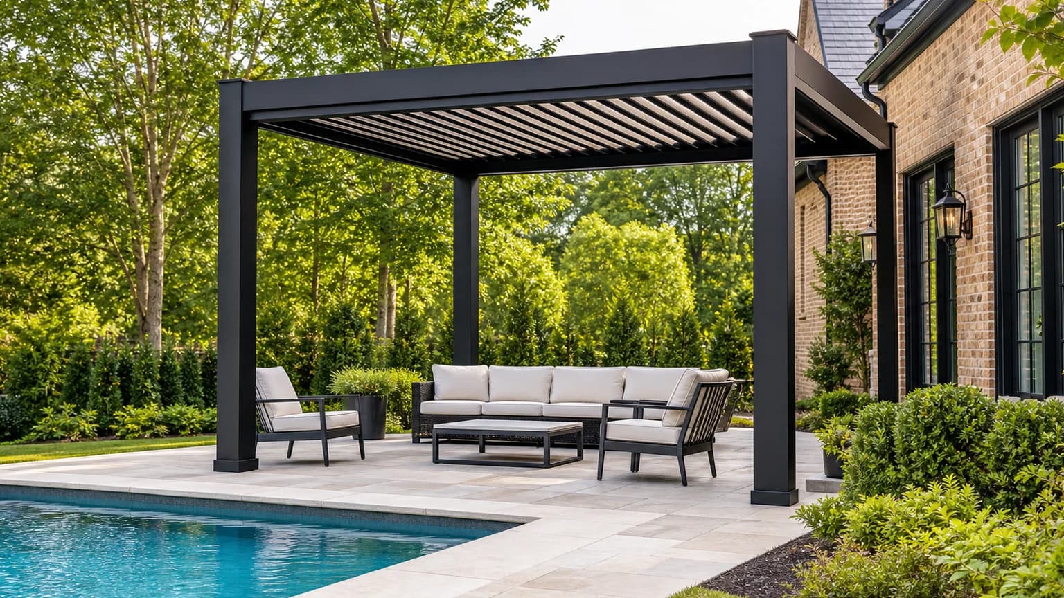 Black aluminum louvered pergola beside a rectangular swimming pool at a Charlotte-area brick home