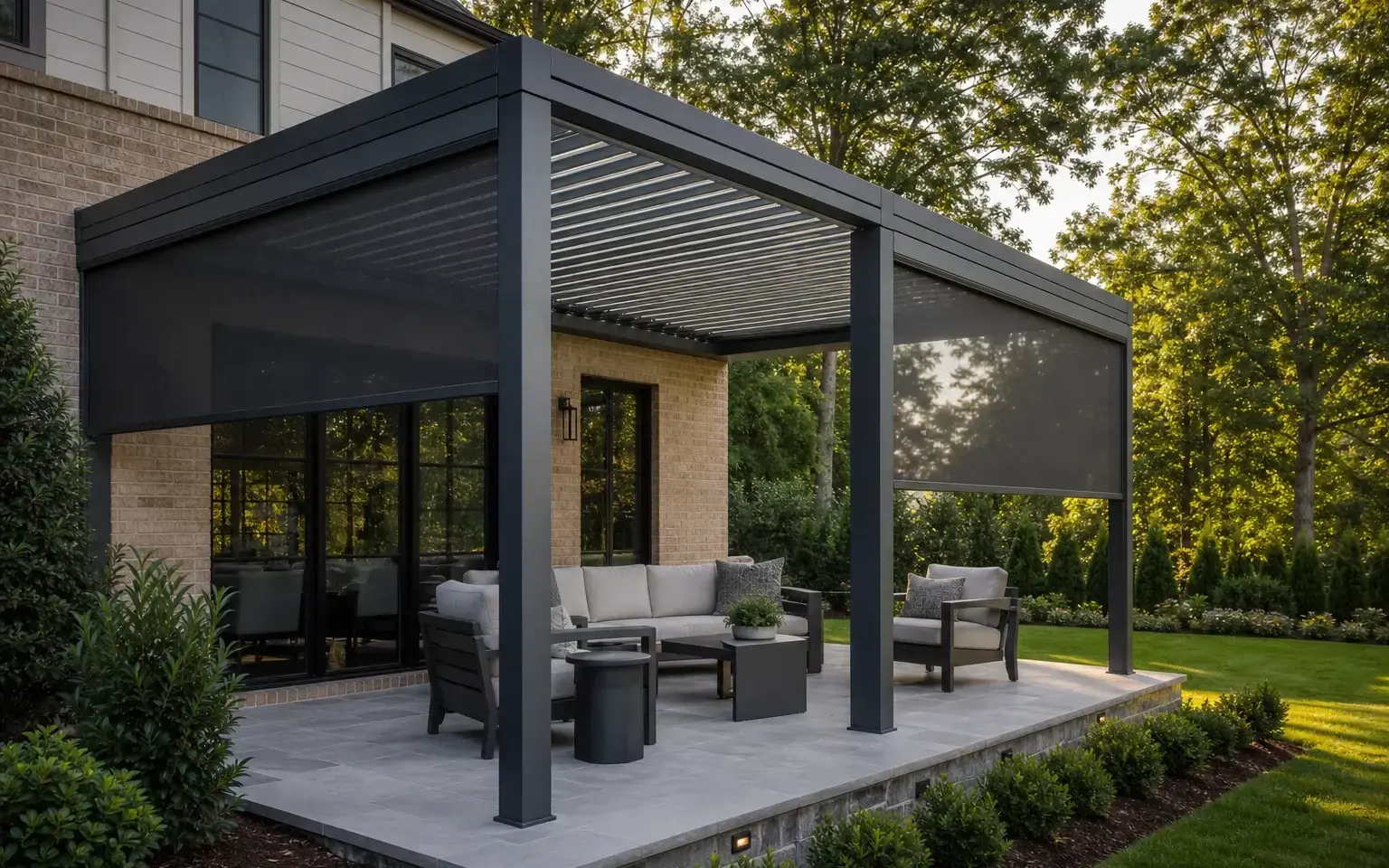 Black aluminum louvered pergola with two integrated charcoal retractable screens over a Charlotte-area patio