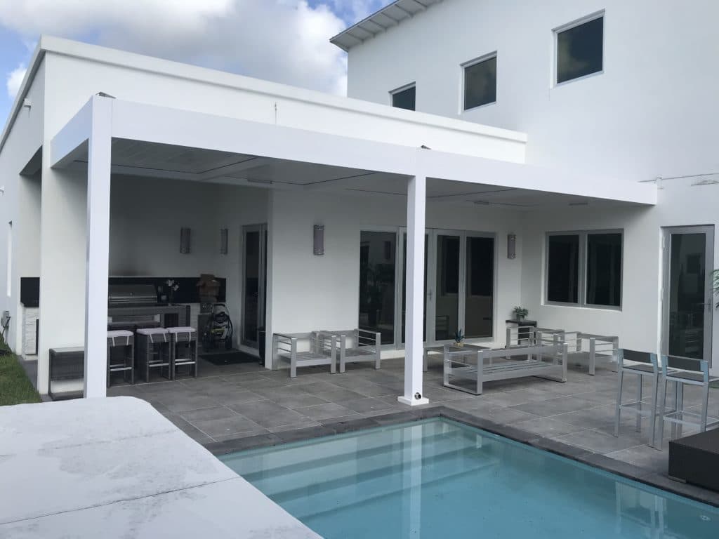 Two white R-BLADE pergolas attached to a home