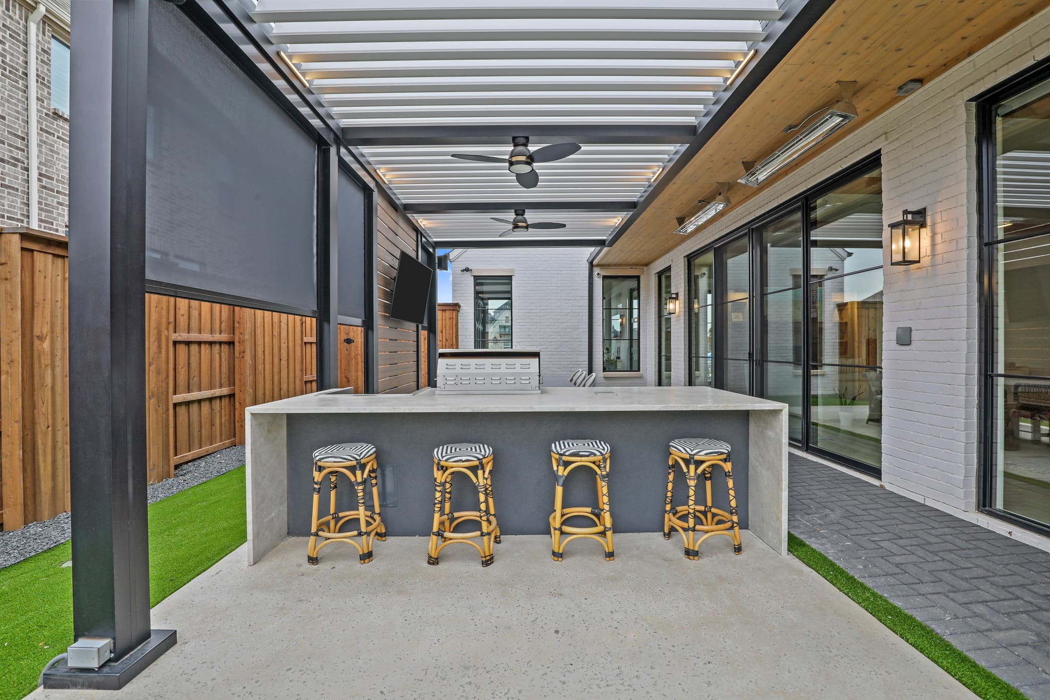 R-BLADE pergola with white louvers and LED lighting over a pool deck