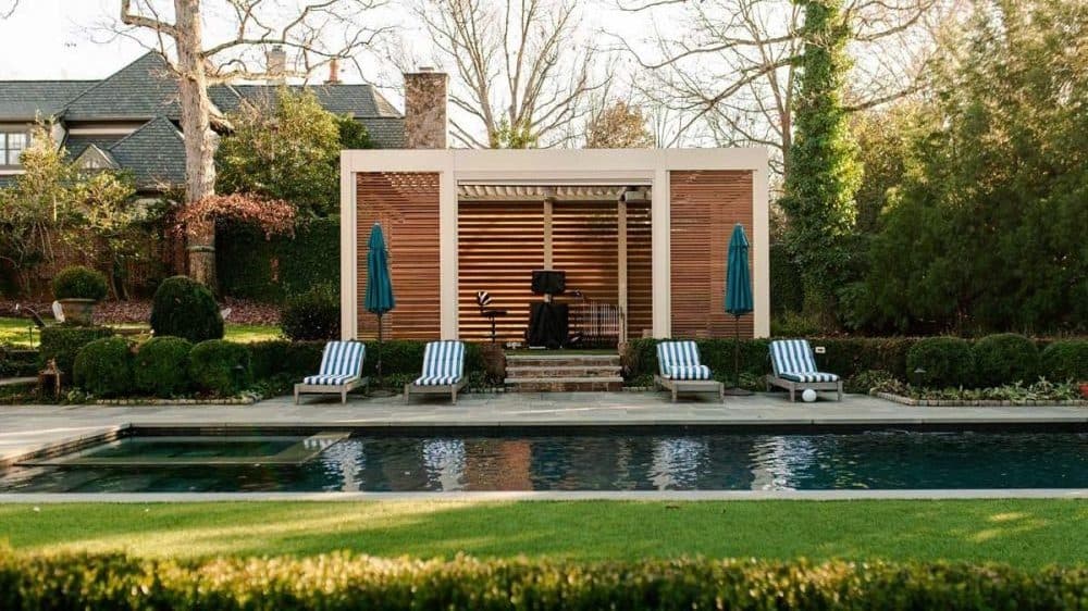 Pergola structure over a home golf simulation and clubhouse space