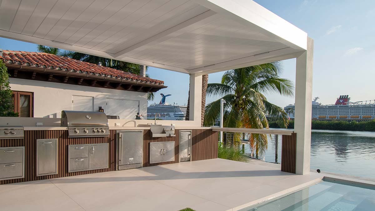 Luxury modern outdoor kitchen under a pergola structure