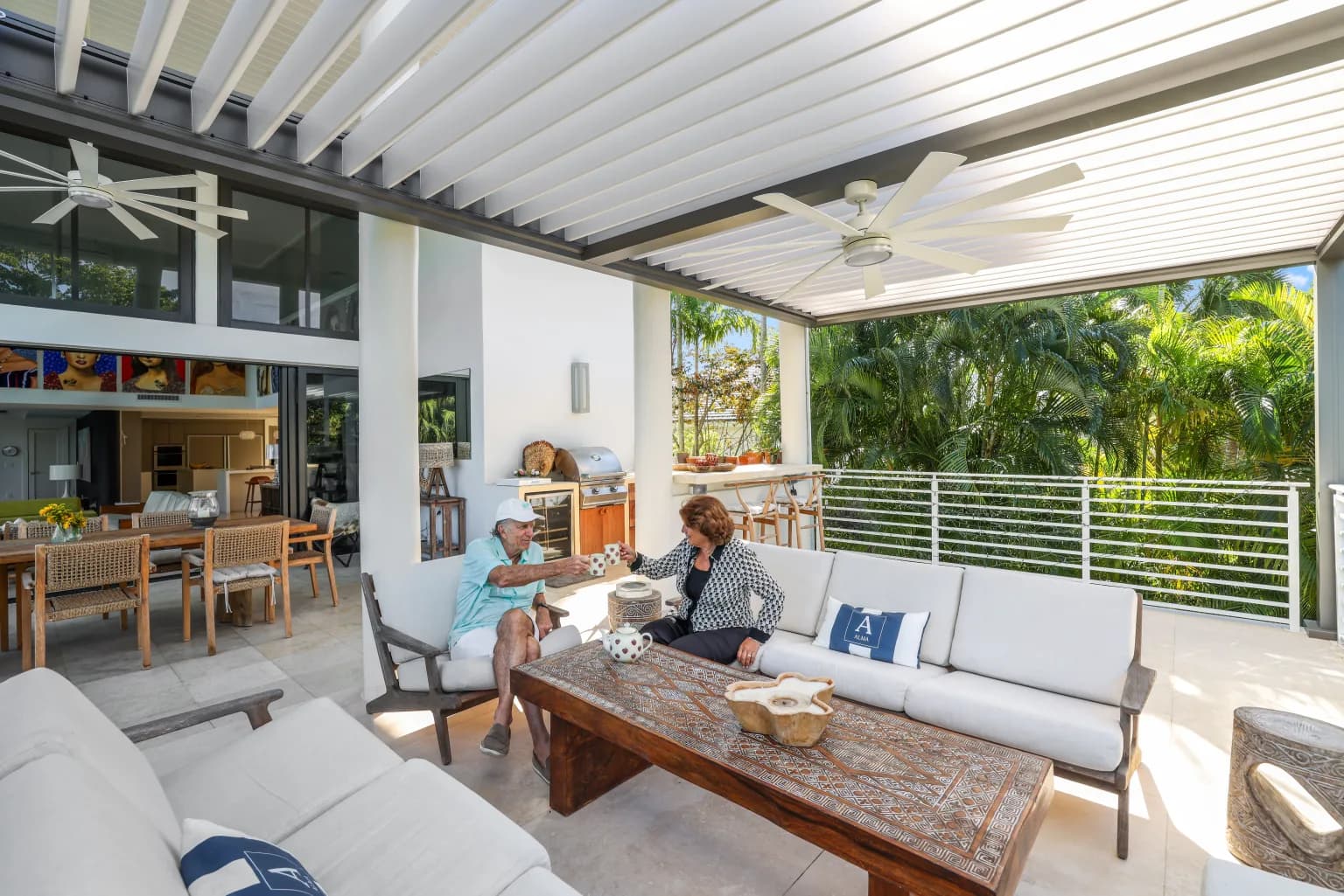 Luxury motorized louvered pergola with integrated lighting beside a pool at dusk