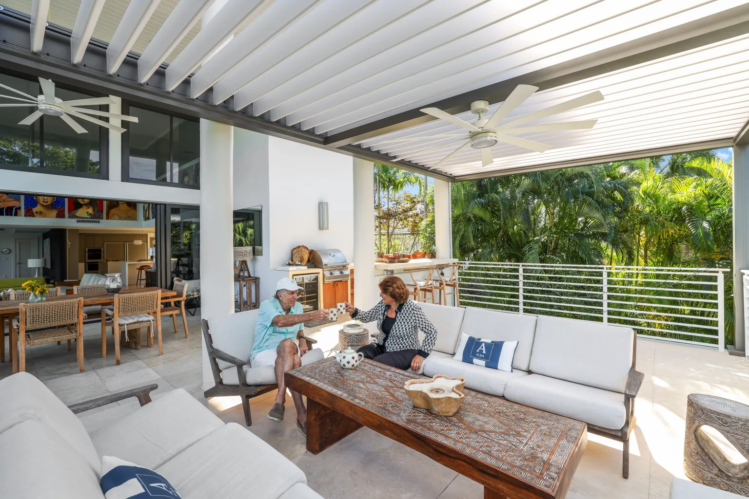 Luxury Azenco R-BLADE pergola with integrated lighting beside a pool at dusk